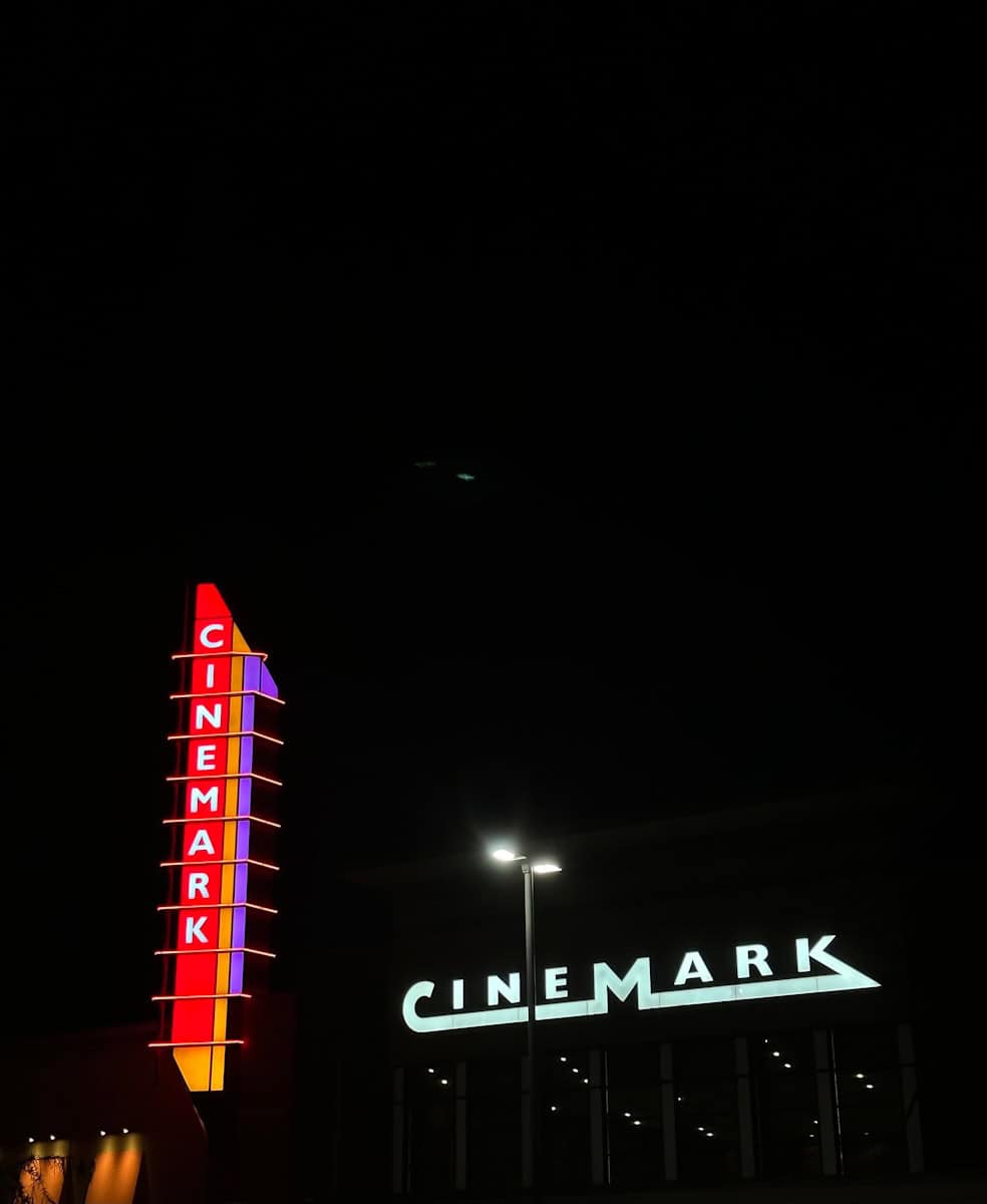 a large neon sign is lit up in the dark