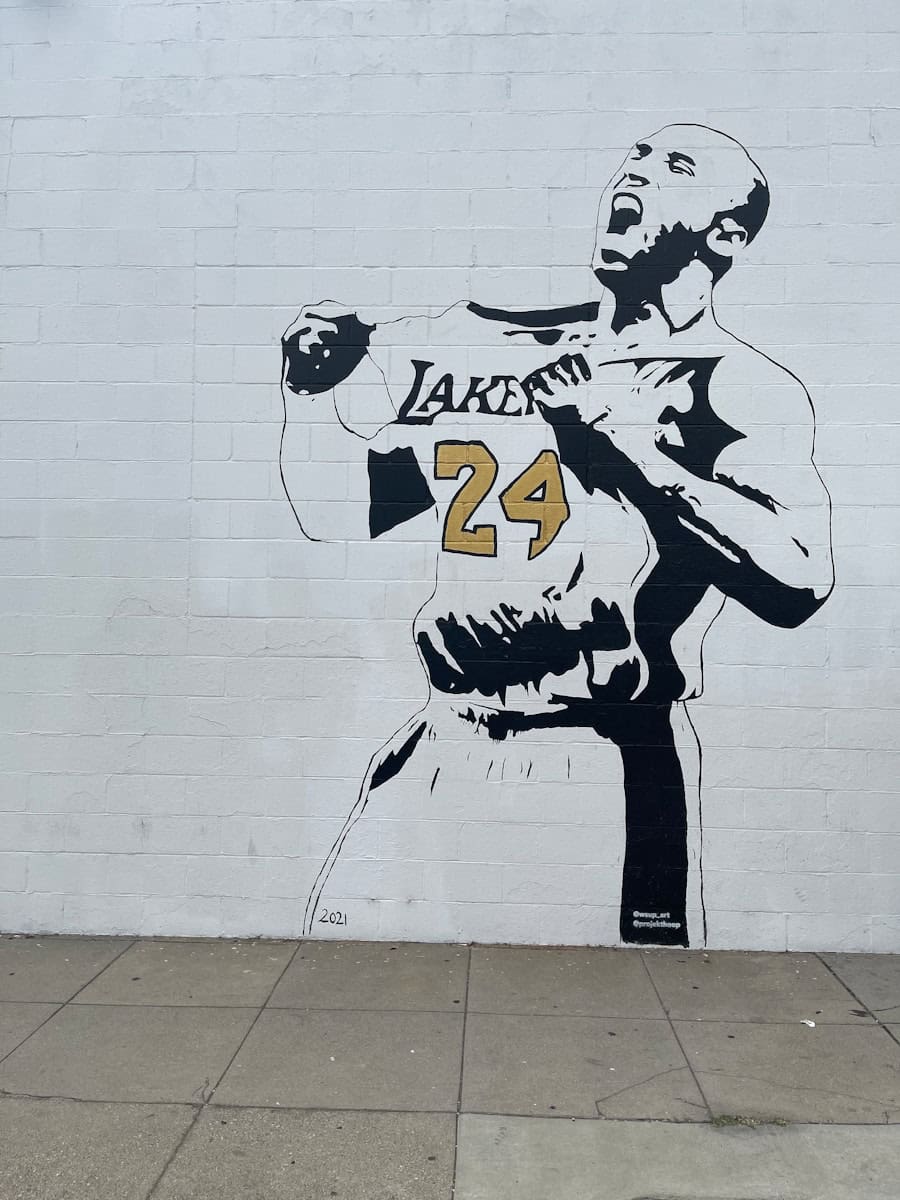 a mural of a man holding a basketball jersey