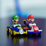 lego mini figure riding blue and red toy car